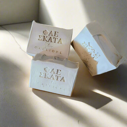 Three bars of soap with visible branding on a light background