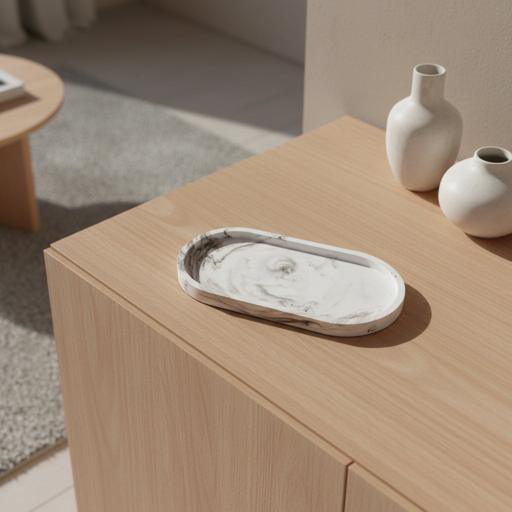 Marble tray on a wooden surface with two vases in the background