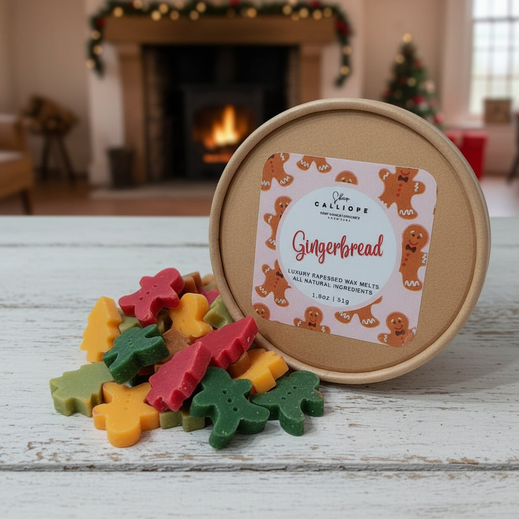 Colorful gingerbread-shaped wax melts in front of a round container with a label, set against a festive background.