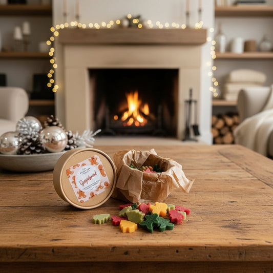 Colorful gingerbread cookies on a wooden table with a fireplace in the background