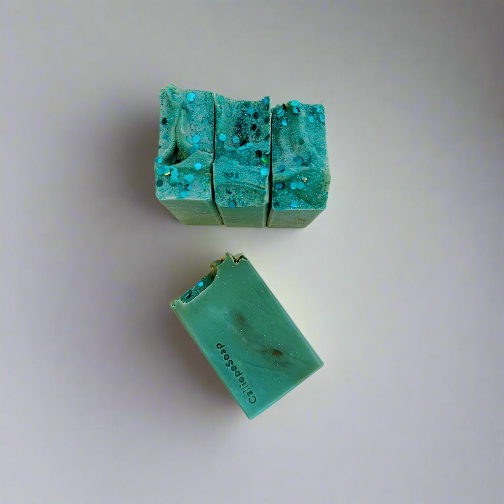 Green soap bars with a textured surface on a light gray background