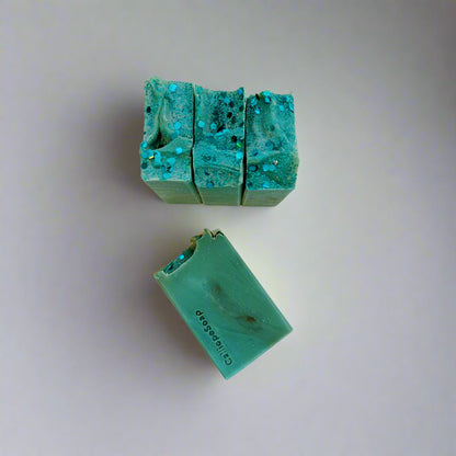 Green soap bars with a textured surface on a light gray background