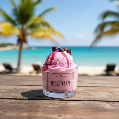 Pink ice cream candle in a container with a label on a wooden surface.