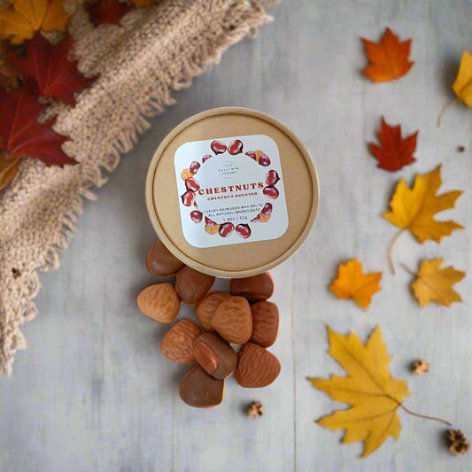 craft container with chestnuts wax melts and a label on a beige surface