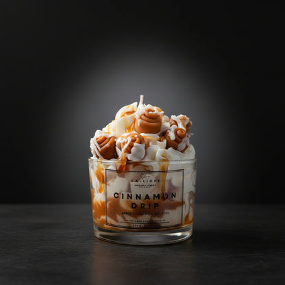 Candle with cinnamon drip design on a dark background