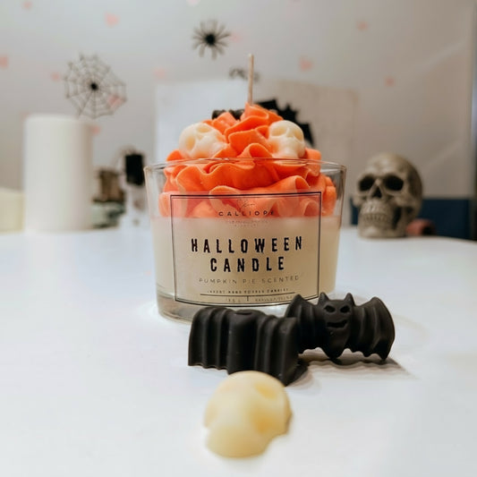 Halloween-themed candle with decorative elements on a white surface