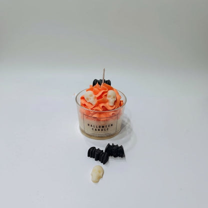 Halloween-themed candle with decorative elements on a white background