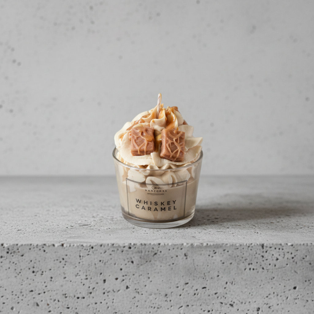 Κοντινό πλάνο gourmet κεριού σόγιας Whiskey Caramel με λεπτομέρειες από σαντιγί κεριού και κύβους καραμέλας