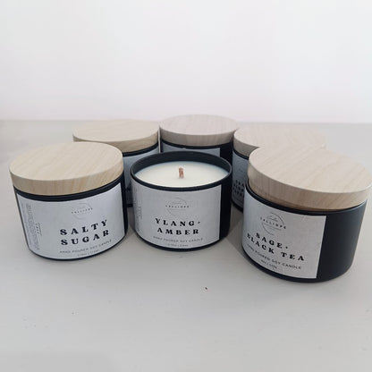 Set of candles with labeled containers on a white background
