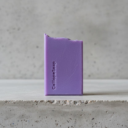 Purple bar of soap with 'CalliopeSoap' branding on a light surface.