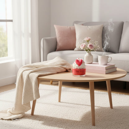 Round wooden coffee table with decorative items in a living room setting.