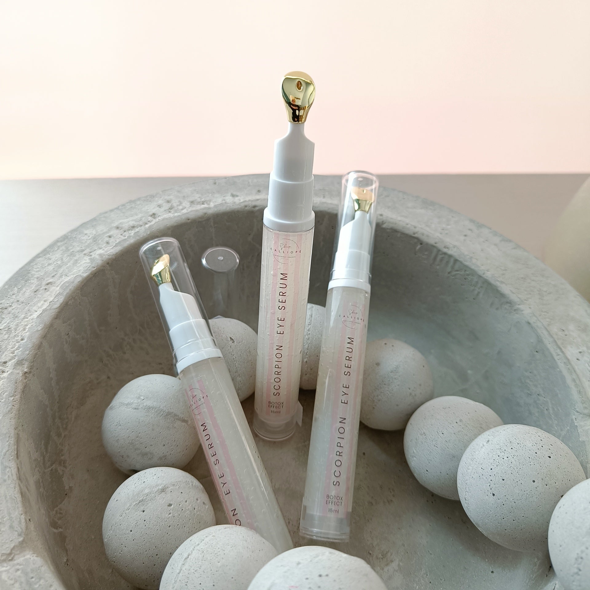 eye serum tubes in concrete bowl with concrete beads