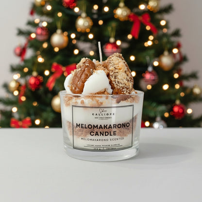 Melomakarono scented candle in a glass jar with decorative elements on a white surface.