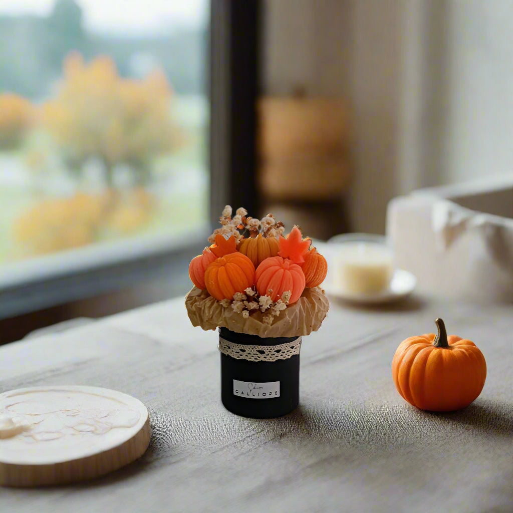 Decorative item with pumpkins on a table near a window
