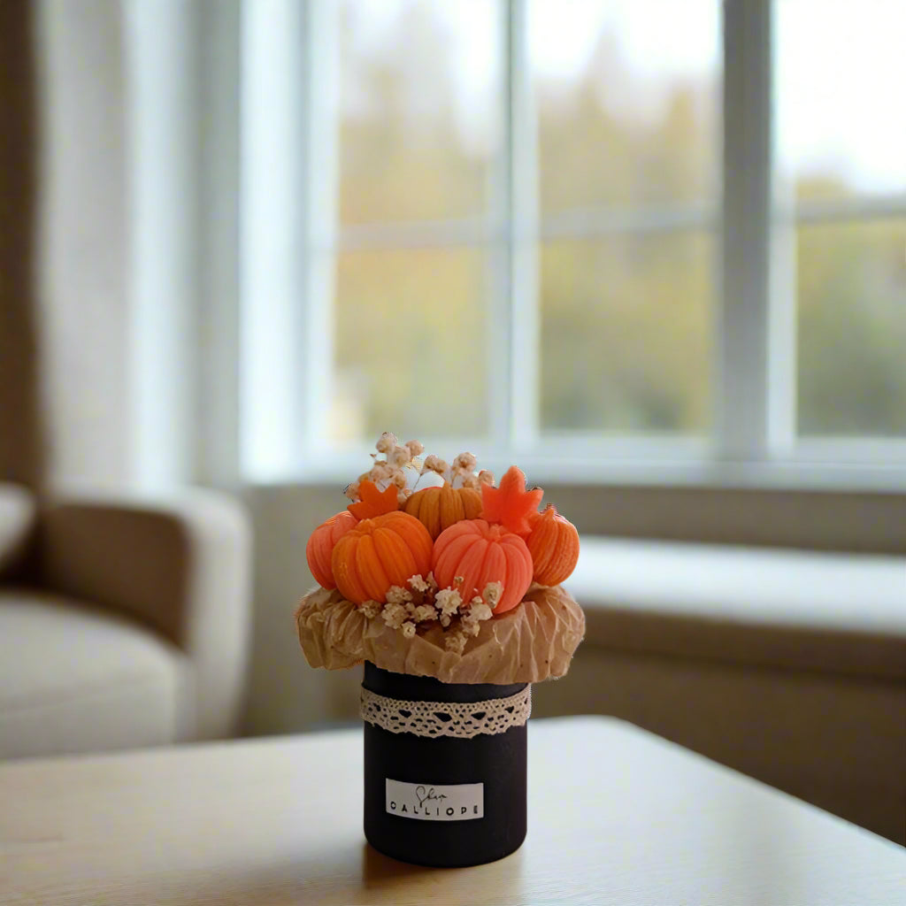 Decorative arrangement of pumpkins in a vase on a table with a blurred background