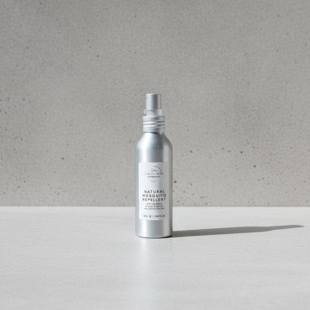 Silver spray bottle labeled 'Natural Insect Repellent' on a wooden surface.