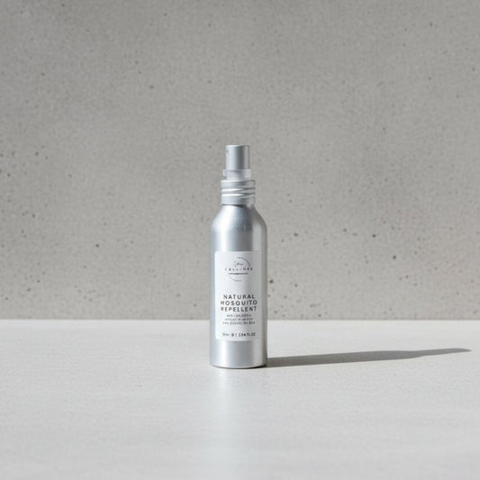 Silver spray bottle labeled 'Natural Insect Repellent' on a wooden surface.