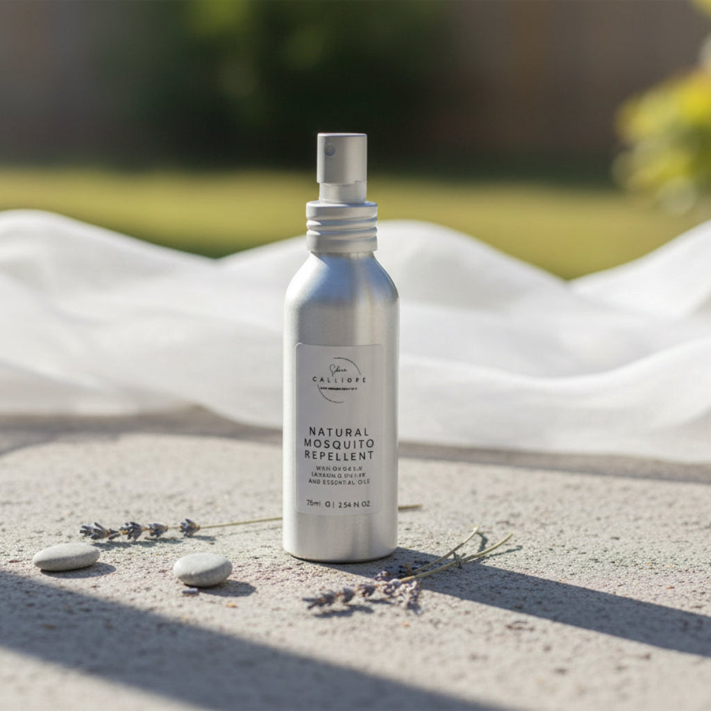 Silver spray bottle labeled 'Natural Mosquito Repellent' on a concrete surface.