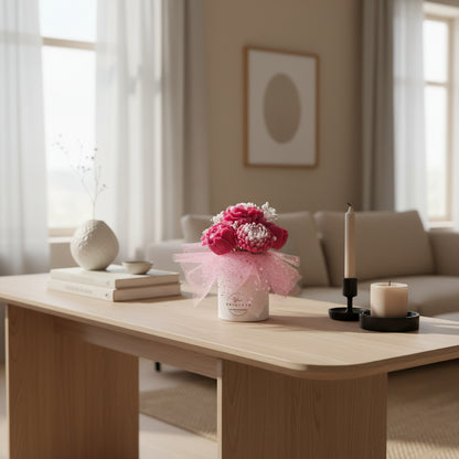 Decorative table with candle bouquet, books, and candles in a living room setting