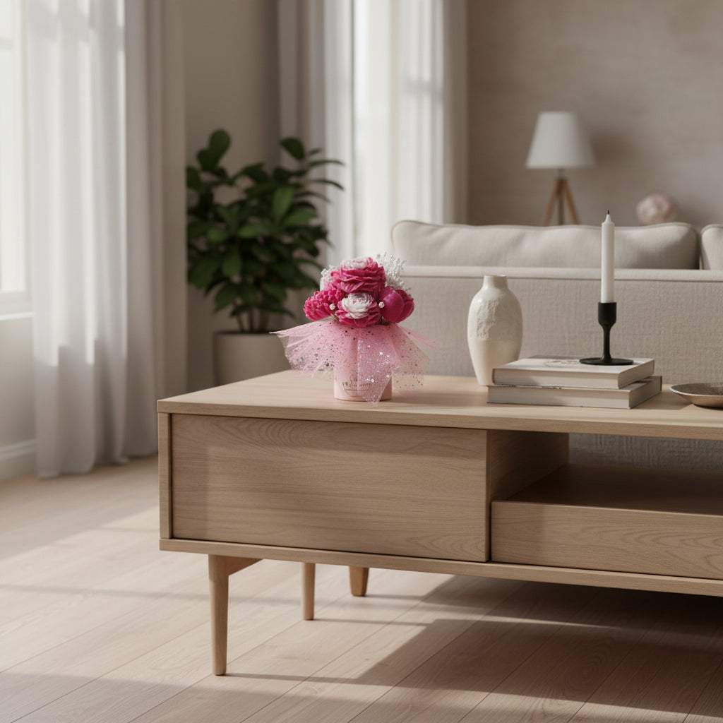Wooden coffee table with a candle bouquet and decorative items in a living room setting