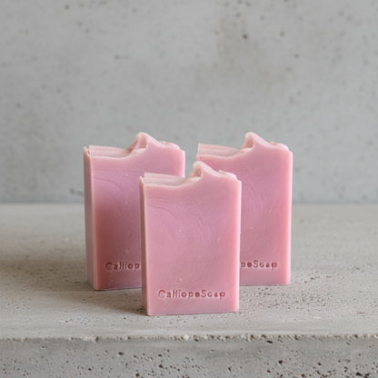 Three bars of pink soap with 'Calliope Soap' branding on a white background