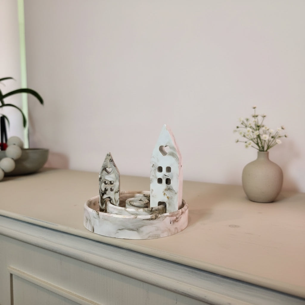 Marble-patterned candle holder with a bowl on a light surface