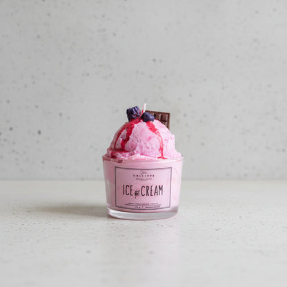 Pink ice cream with toppings in a container labeled 'Ice Cream' on a table.