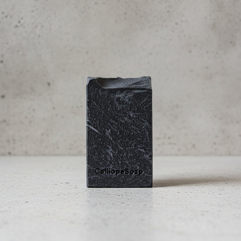 Black soap bar with 'CaliapaSoap' branding on a light surface.