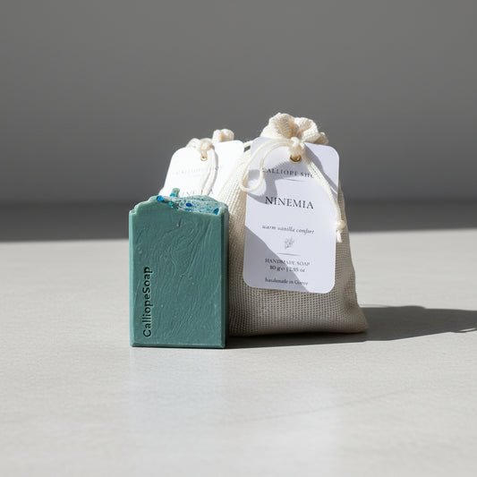 Bar of soap and packaging pounches with a label on a surface, with a blurred background