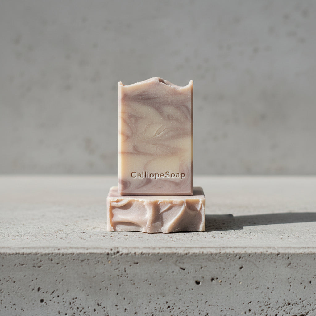 Bar of soap with 'CalliopeSoap' branding on a concrete surface.