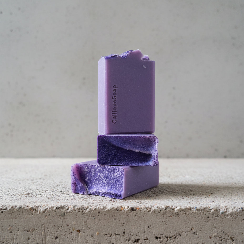 Purple soap bars on a concrete surface with a blurred background
