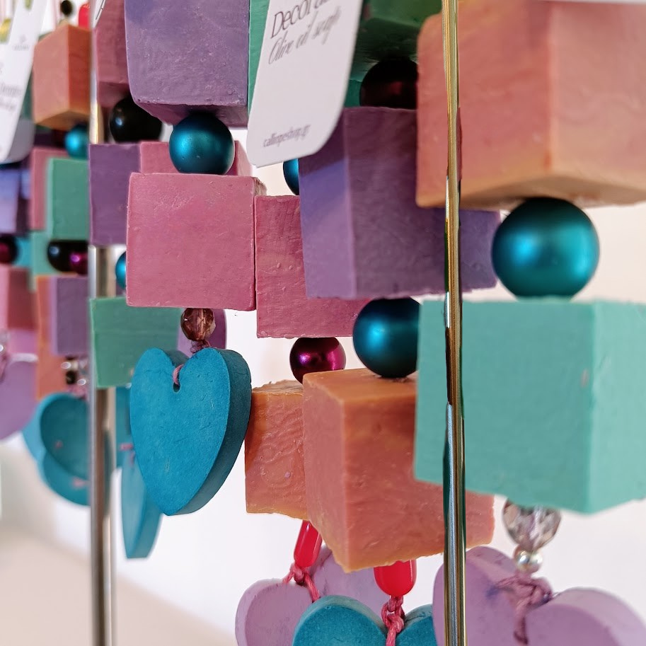 Colorful cube soaps with heart-shaped plaster on a stand