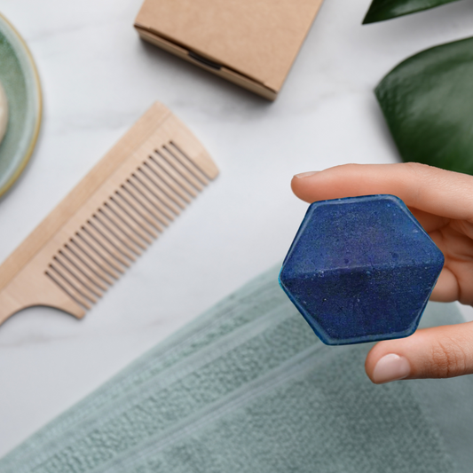 A blue hexagonal solid shampoo bar 