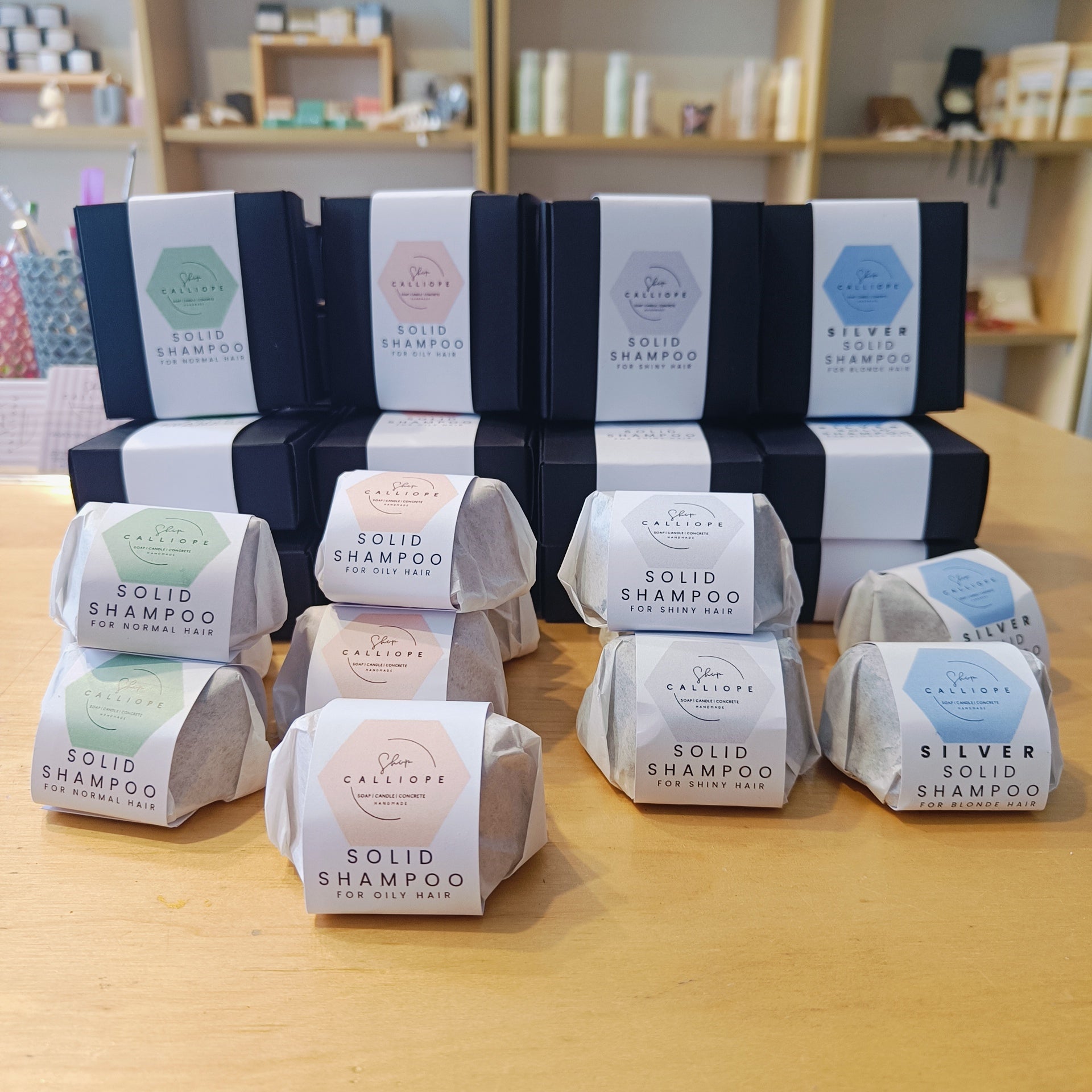 Solid shampoo bars packaged and labeled as solid shampoo for blonde hair, normal hair, oily hair, shiny hair.