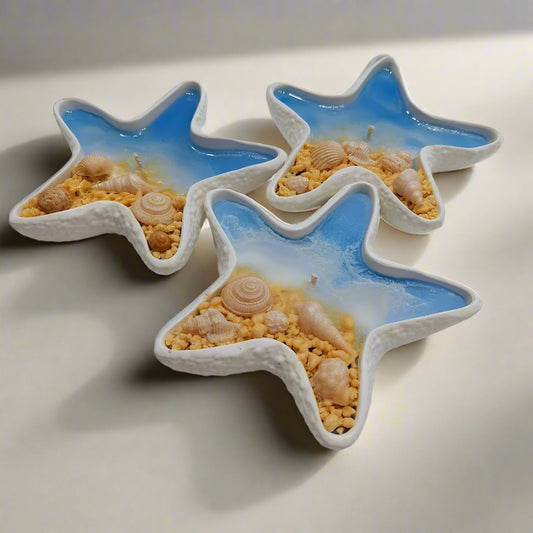 Three star-shaped ceramic dishes with a beach theme on a white surface.