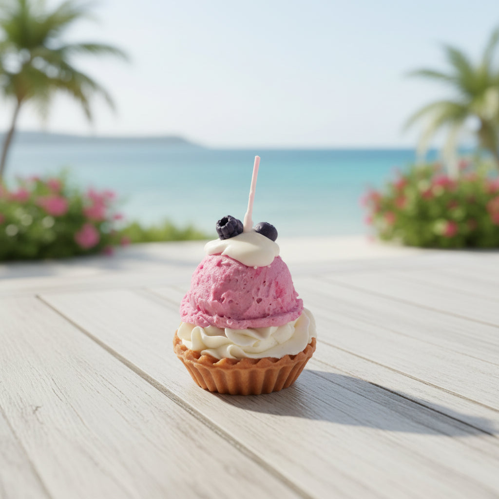 Pink ice cream  candle with white whipped cream and berries on a small cupcake base.