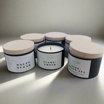 Set of candles with labeled containers on a white background