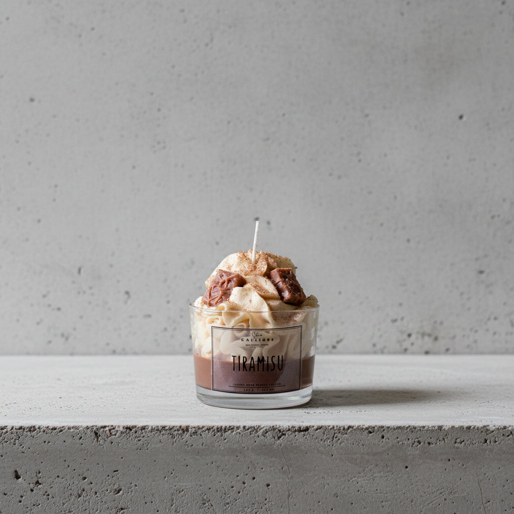 Tiramisu-themed candle with a CalliopeShop label on a surface.