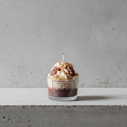 Tiramisu-themed candle with a CalliopeShop label on a surface.