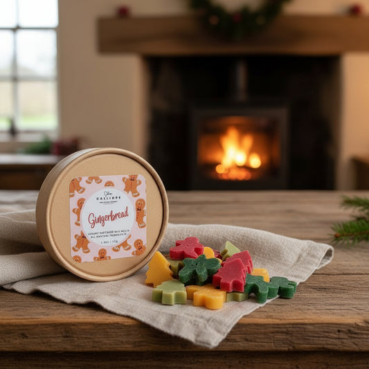 Round wooden container with gingerbread-themed packaging on a table in front of a fireplace.