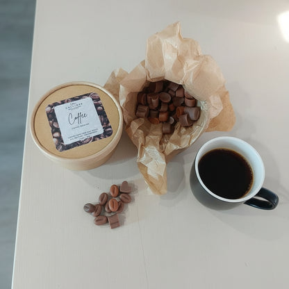 Coffee beans wax melts in a craft box, container, and cup on a white surface