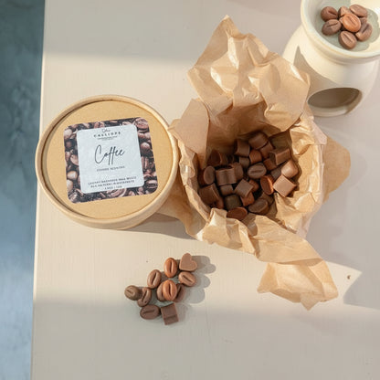 Craft box with coffee-themed packaging and coffee beans wax melts on a light surface