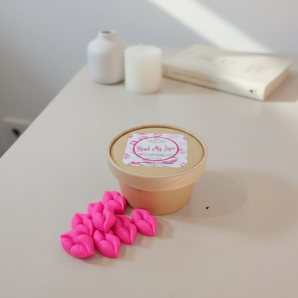 Pink lip-shaped wax melts with a craft container and 'Read My Lips' label on a light background