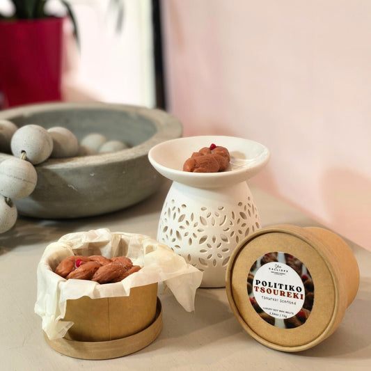 tsoureki wax melts in a craft box and white wax burner on a light surface with a blurred background.