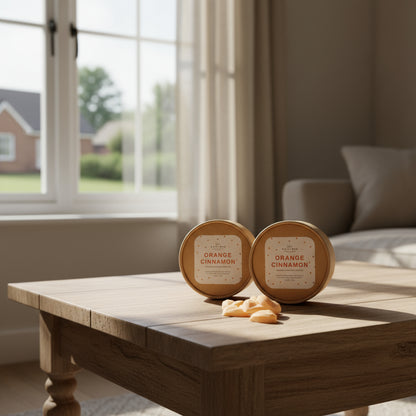 Two craft boxes labeled 'Orange Cinnamon' on a wooden table with a blurred background