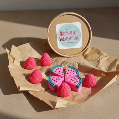 Handmade strawberry and watermelon shaped pink wax melts by CalliopeShop on eco-friendly paper packaging.