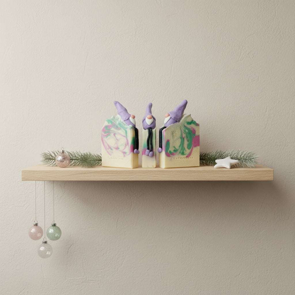 Three gnome-shaped soap bars with colorful swirls on a white background