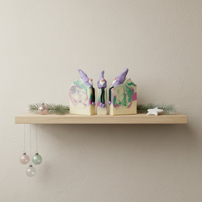 Three gnome-shaped soap bars with colorful swirls on a white background