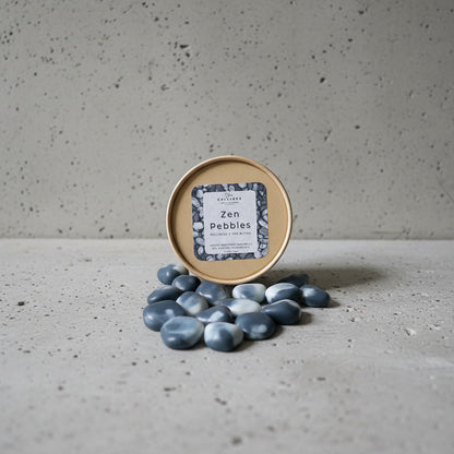 Zen pebbles Wax Melts with a container labeled 'Zen Pebbles' on a light  gray surface.